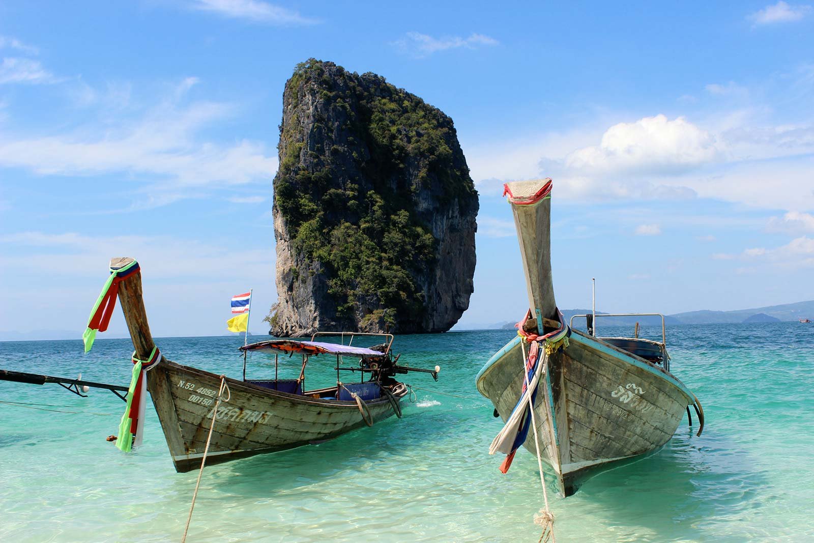 Photo of two longtail boats on the beach of Poda Island Public boat in Thailand-longtail boat
