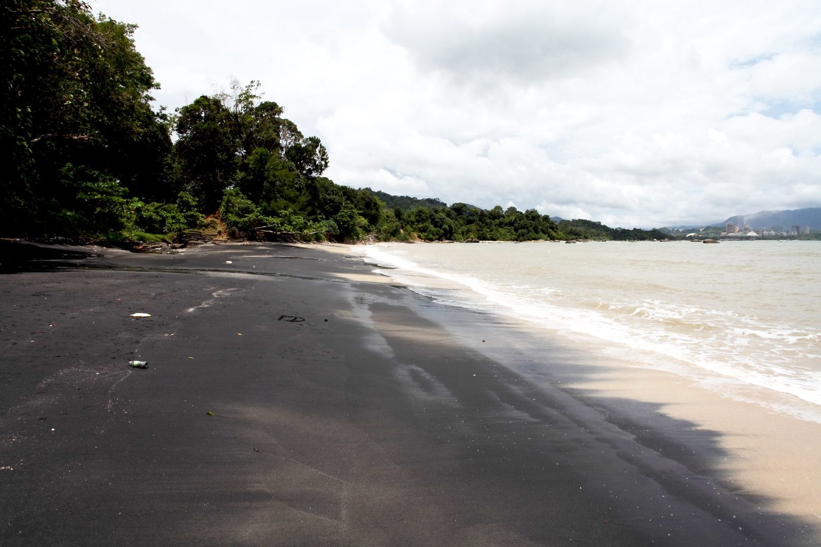 Photo of black sand on Pantai Pasir Hitam beach Pantai Pasir Hitam Beach