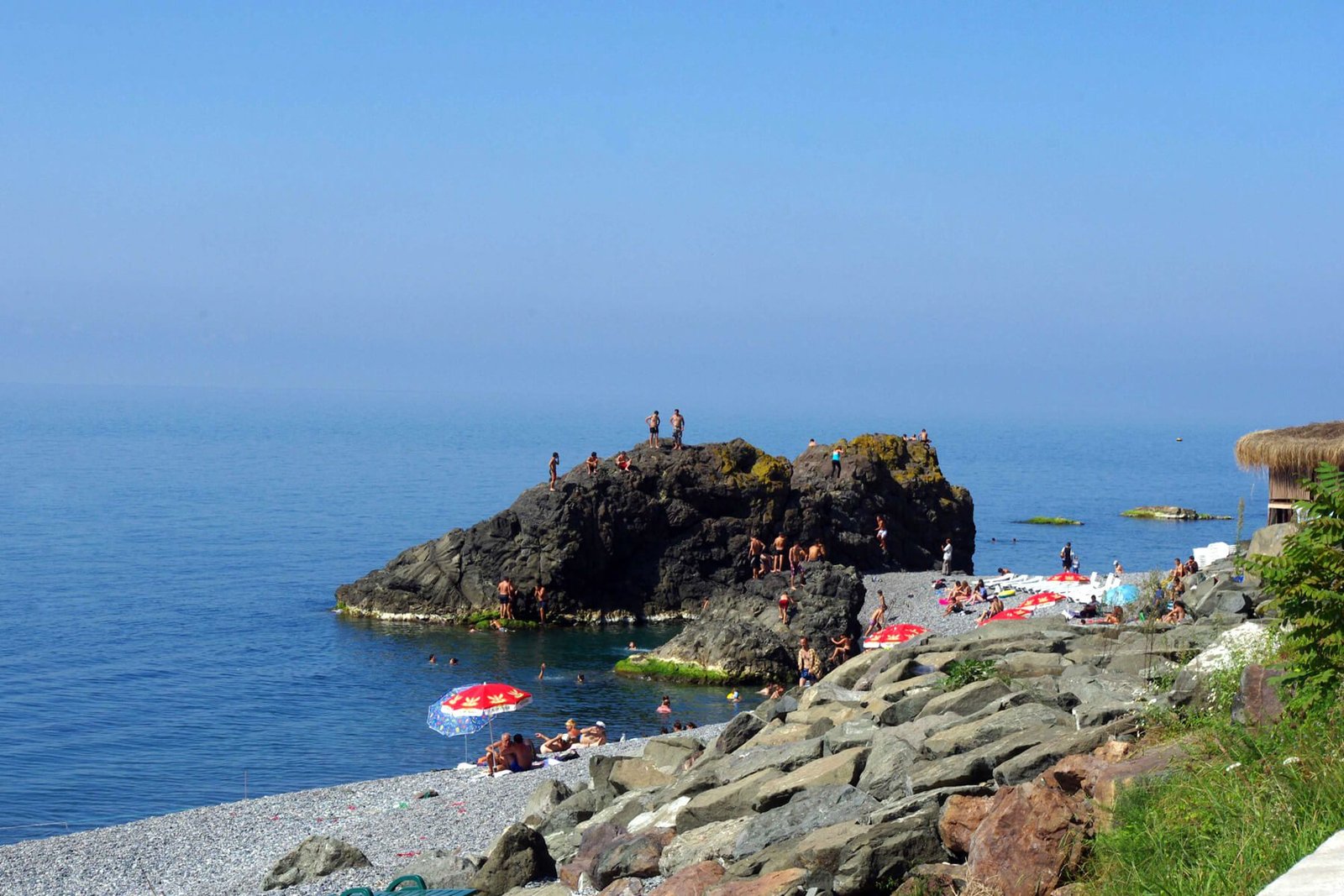 Two rocks from which tourists jump on Sarpi beach in Batumi Springboard for jumping