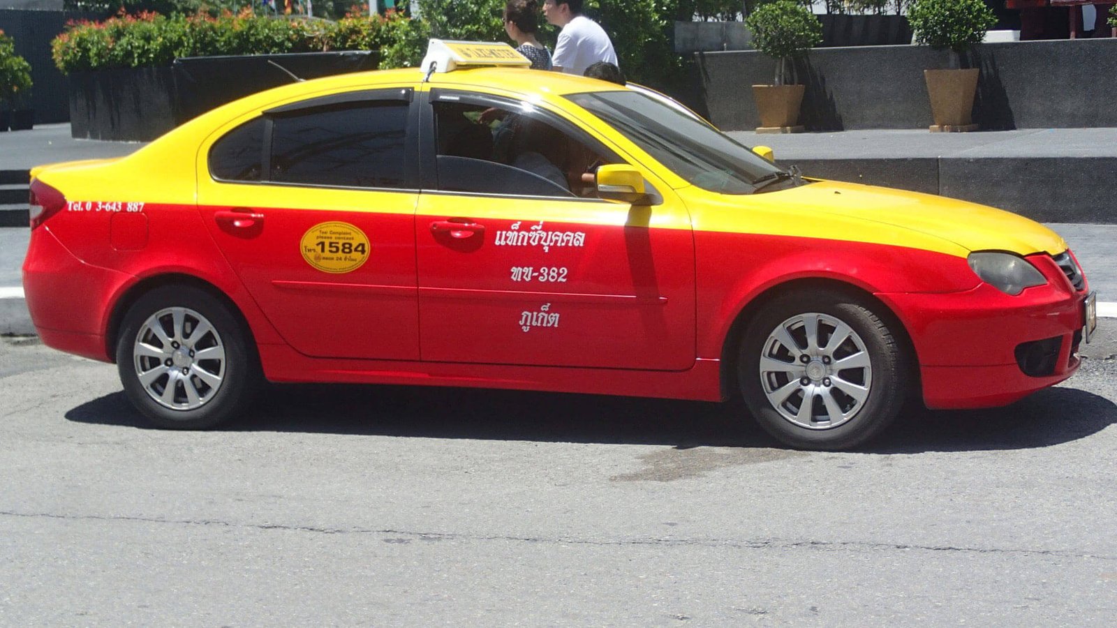 Yellow and red taxi in Phuket, Thailand Phuket Taxi Service