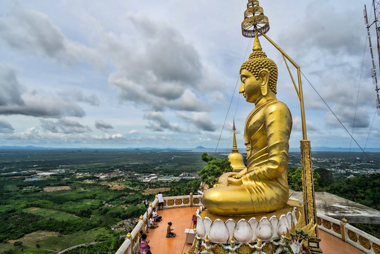 Golden Buddha statue on top of a mountain Golden Buddha Statue