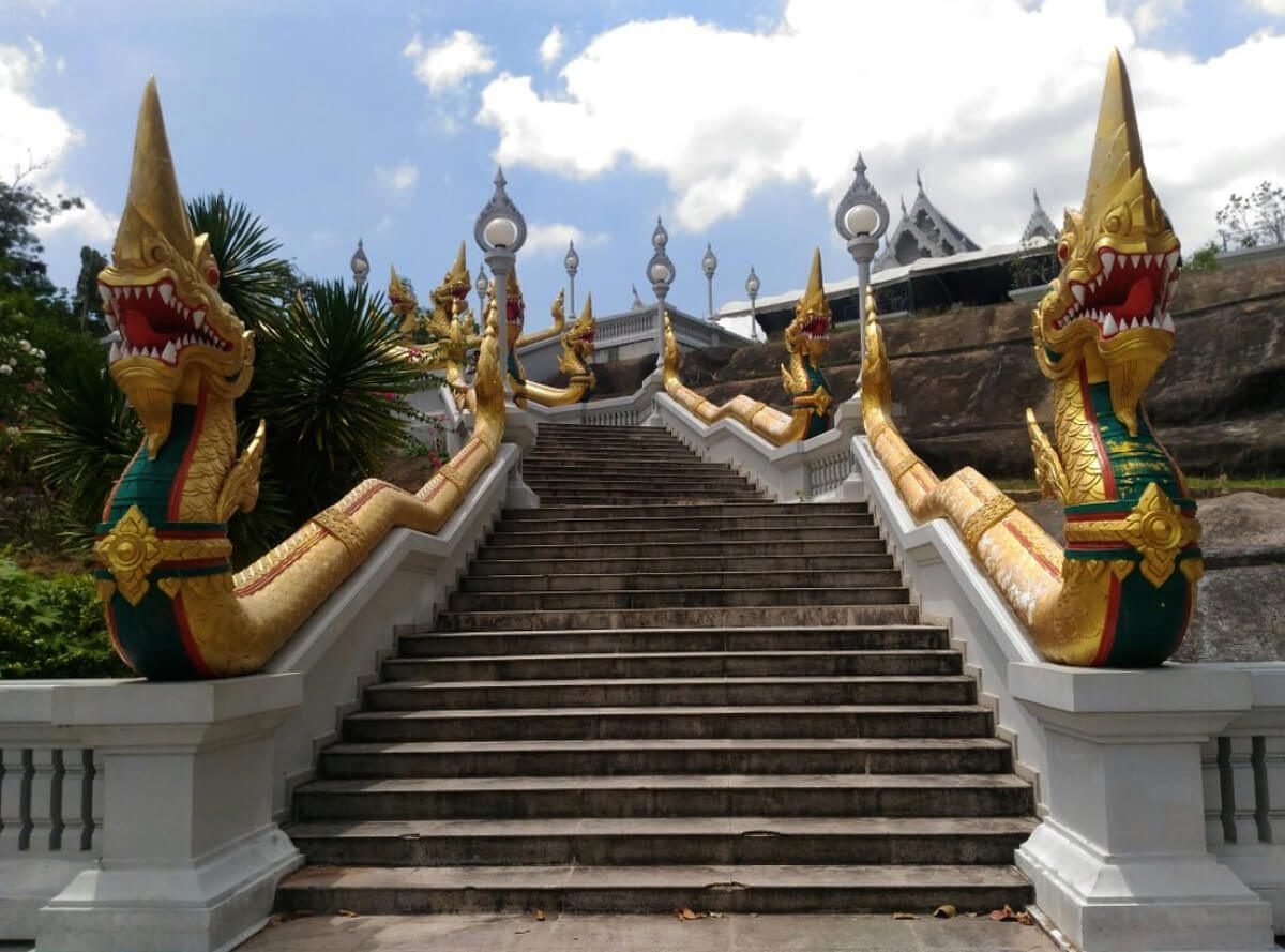 A snow-white staircase, the railing of which is decorated with images of mythological snakes and dragons Stairs to the White Temple