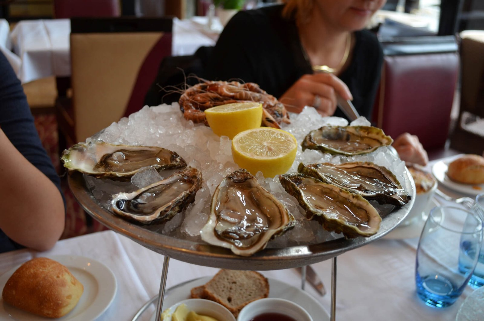 Photo of oysters on a plate on ice with lemon Oysters are another national product