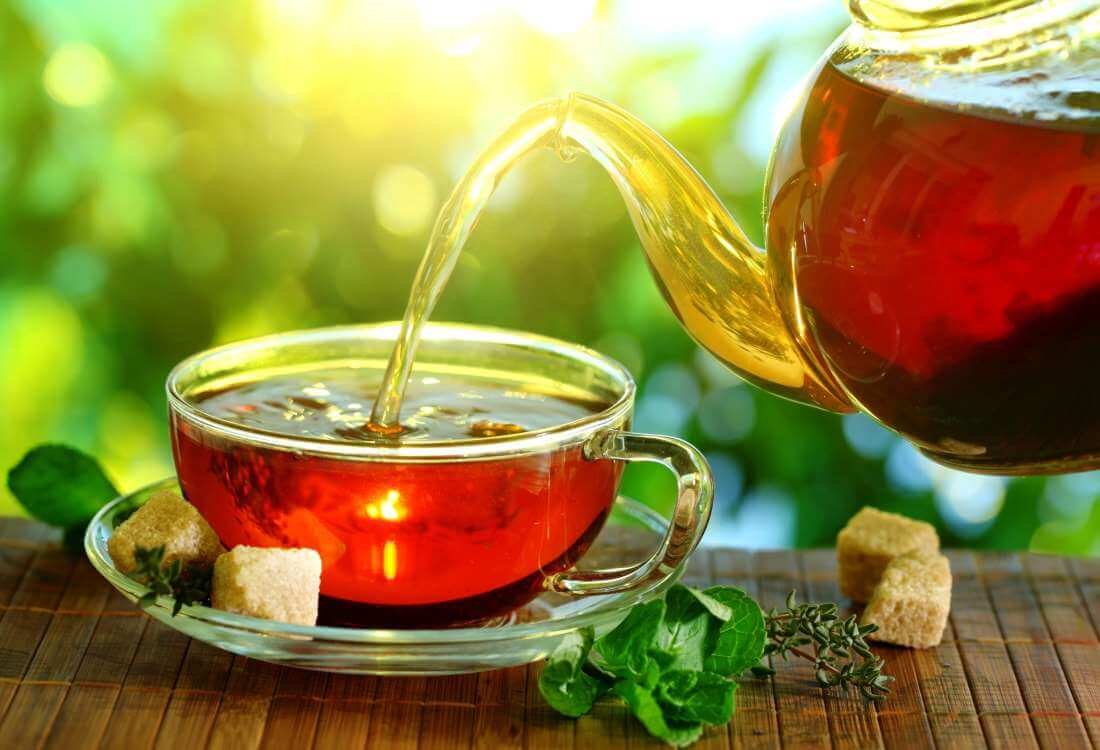 Tea is poured into a cup from the teapot The main drink on the island is tea
