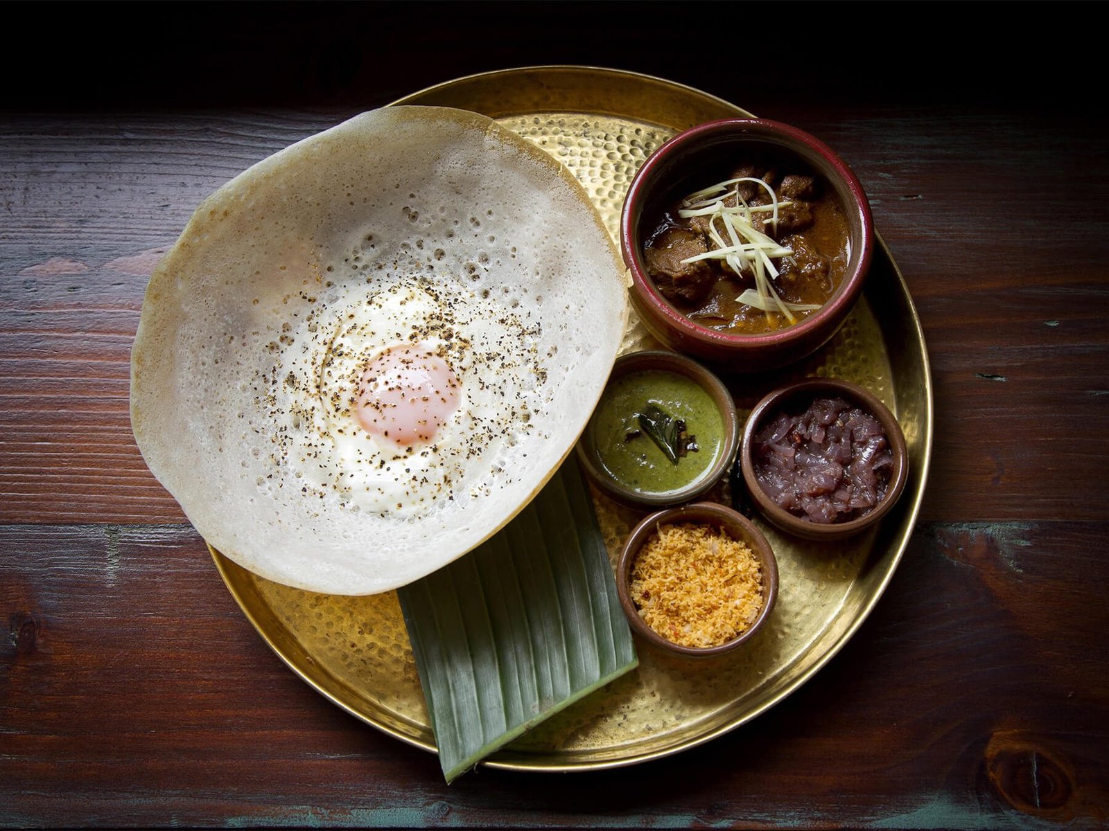 Hoppers with scrambled eggs in the center of the pancake Hoppers or appa