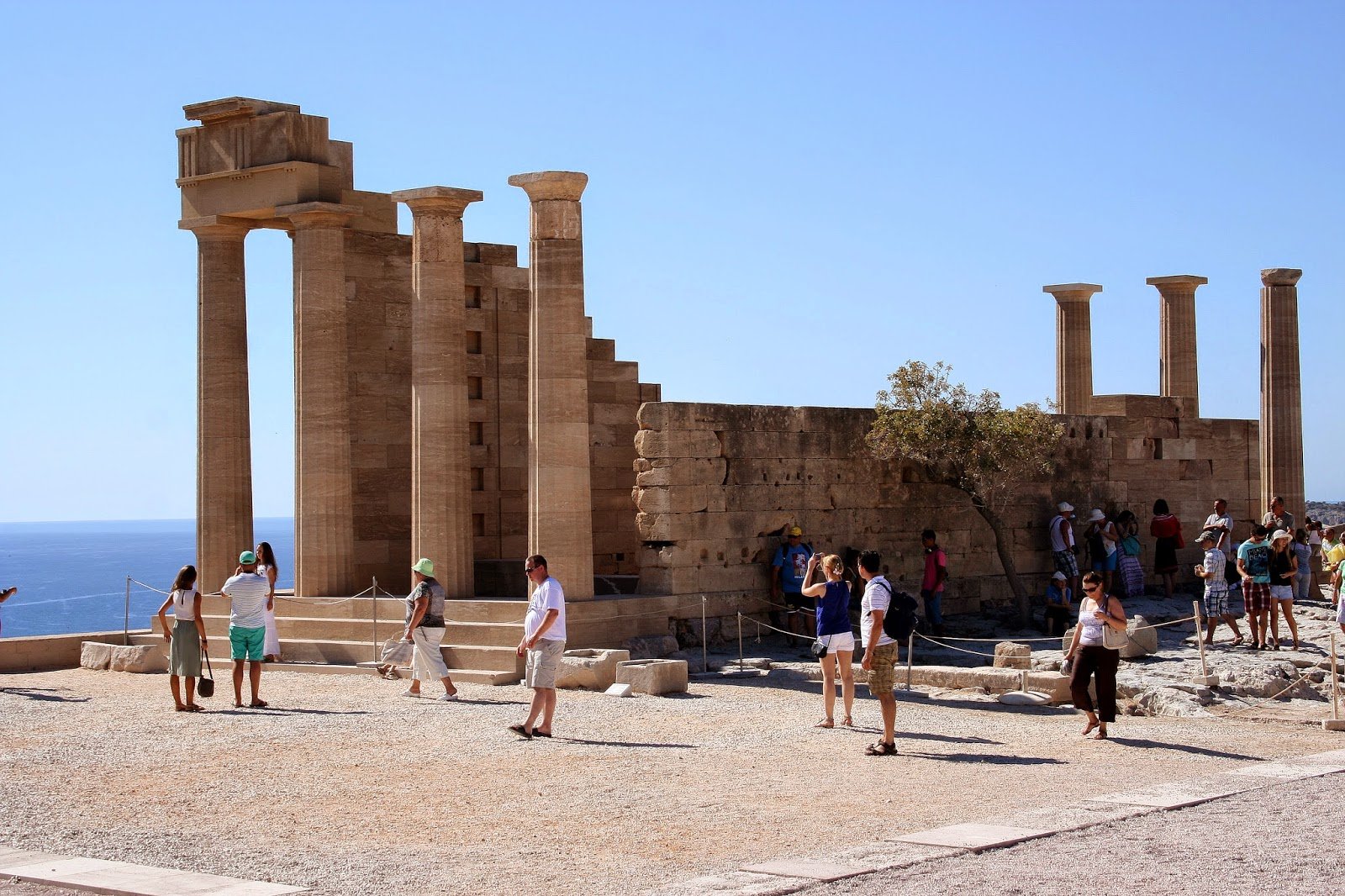 Tourists at the Temple of Athena in the Acropolis of Lindos, Rhodes Discover the sights of Rhodes