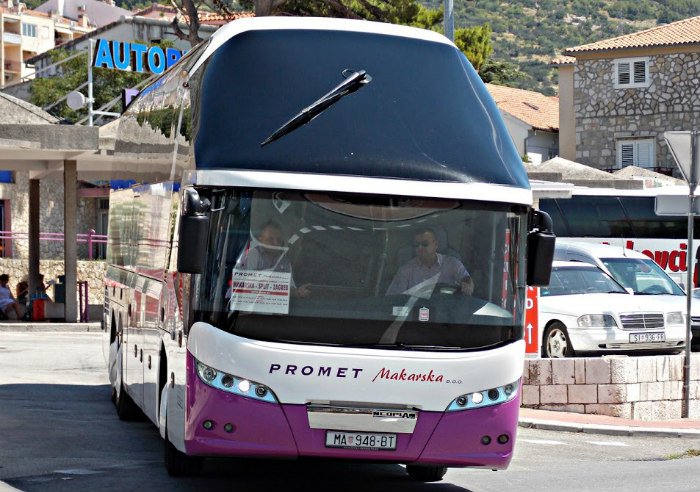 White bus with purple Promet lettering Promet Bus