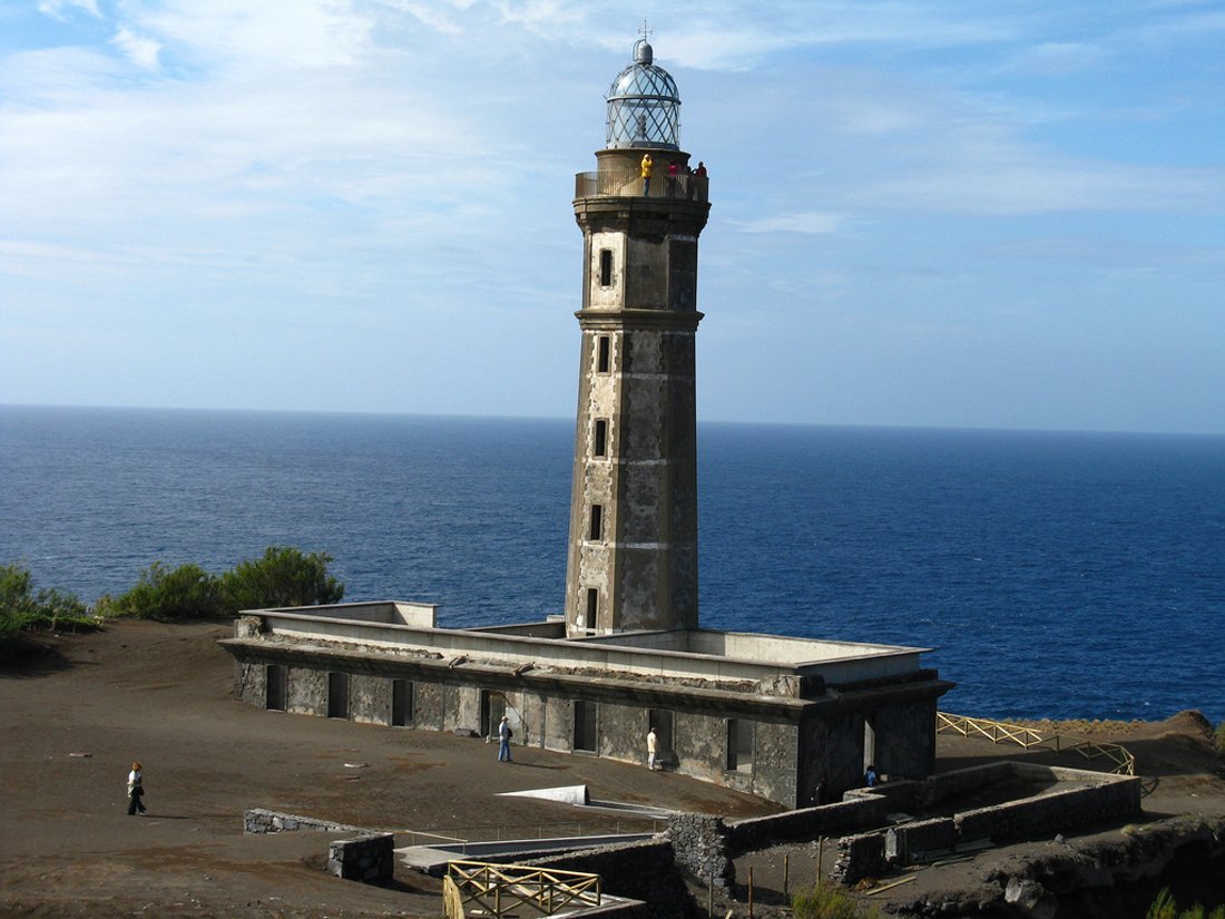 Photo of the lighthouse on the island of Faial next to the volcano Capelinhos A lighthouse that once stood on the edge of the island