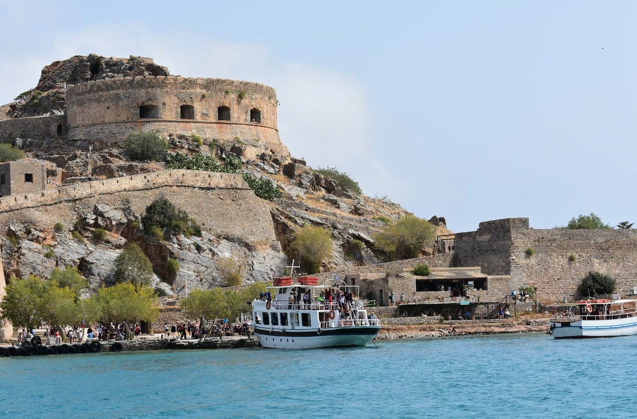 View of the moored boats next to the pier of Spinalonga Island Spinalonga Island Tour in Greece