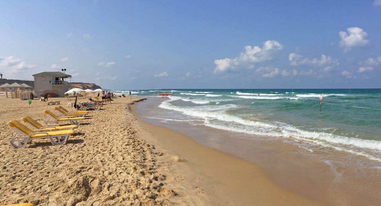 Beach chairs on a sandy beach in Netanya Beach holidays in Netanya