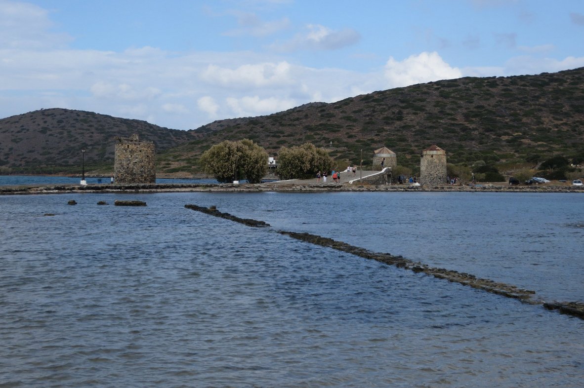 In the photo windmills and a stone bridge Chiona Beach