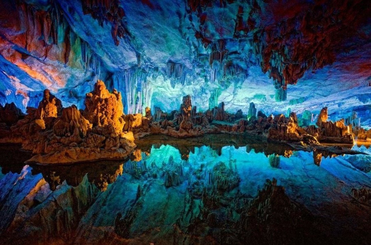 Stalactite cave with multicolored lighting in the Sataplia Nature Reserve Stalactite Cave