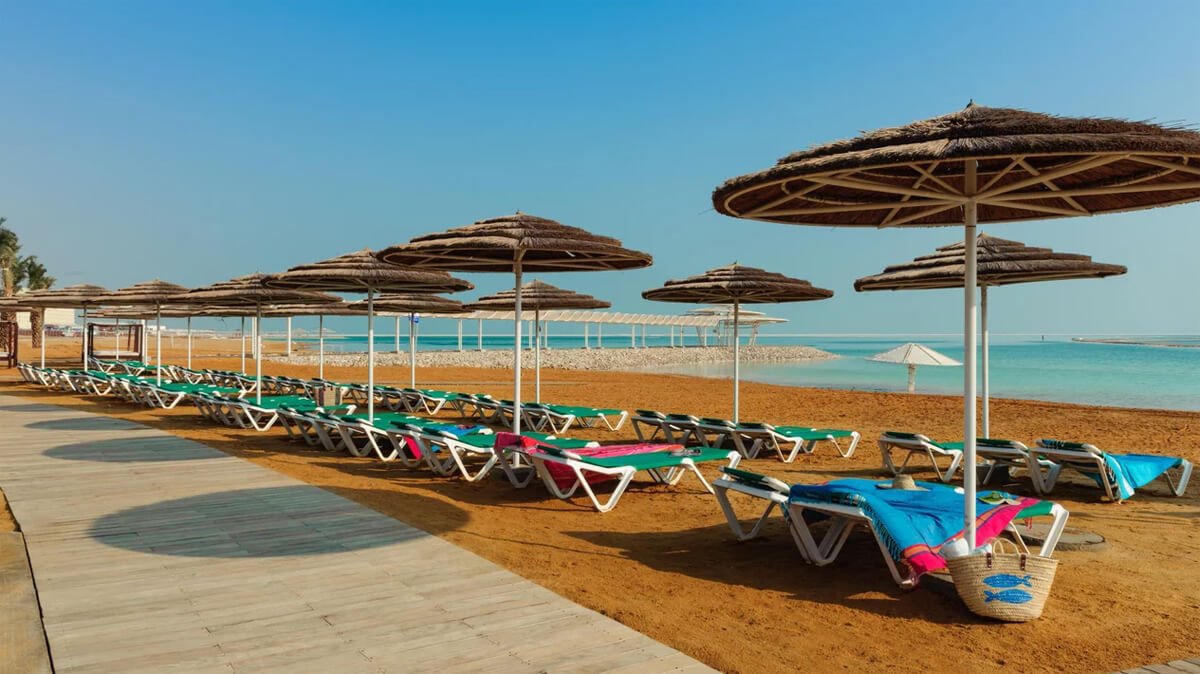 Beach equipped with sun beds and umbrellas in the area of Hotel Leonardo, Hamei Zohar Beach area of the Leonardo Hotel