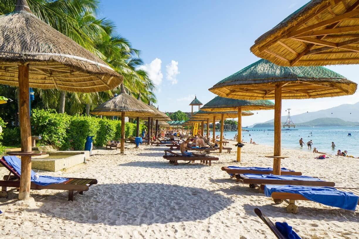 Sandy beach with straw umbrellas on Hong Cho Island near Nha Trang Hong Cho Island Beach