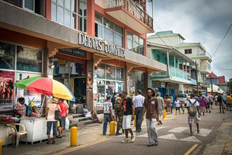 People on one of the central streets of Victoria, Mahe Island, Seychelles One of the city's streets