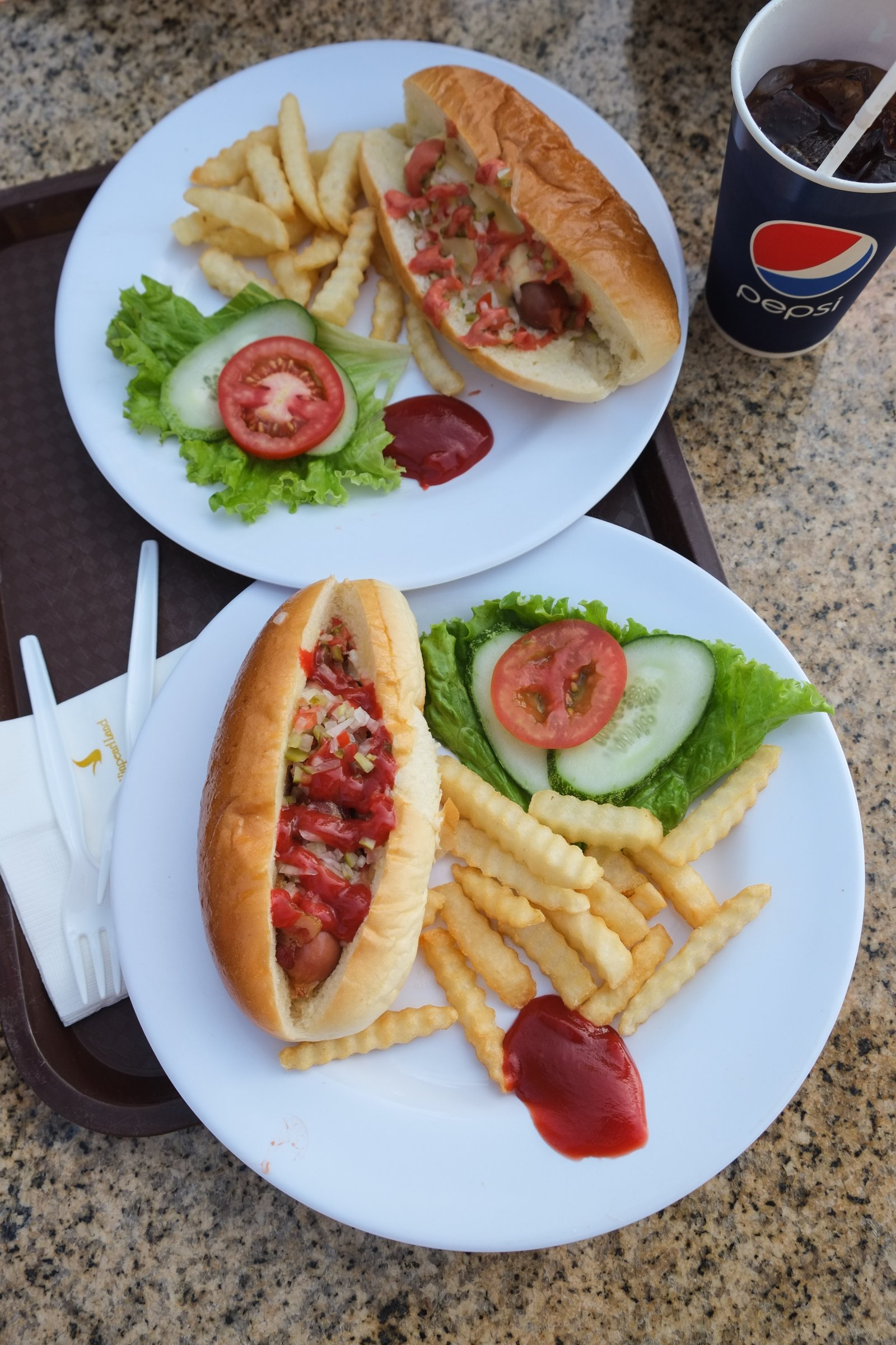 Hot dogs and French fries with Pepsi glasses Fast food in one of the cafes