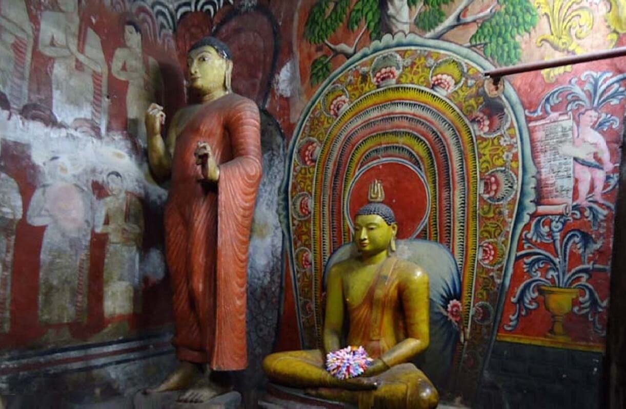Buddha and Monk sculptures in Deva Raja Vihariya Cave of Dambulla Temple complex Sculptures in Deva Raja Cave, Dambulla
