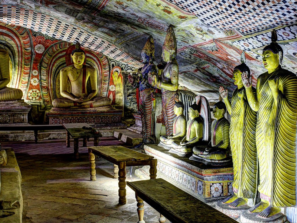 Standing and sitting Buddha sculptures and painted ceiling at Maha Raja Vihariya Cave, Dambulla
