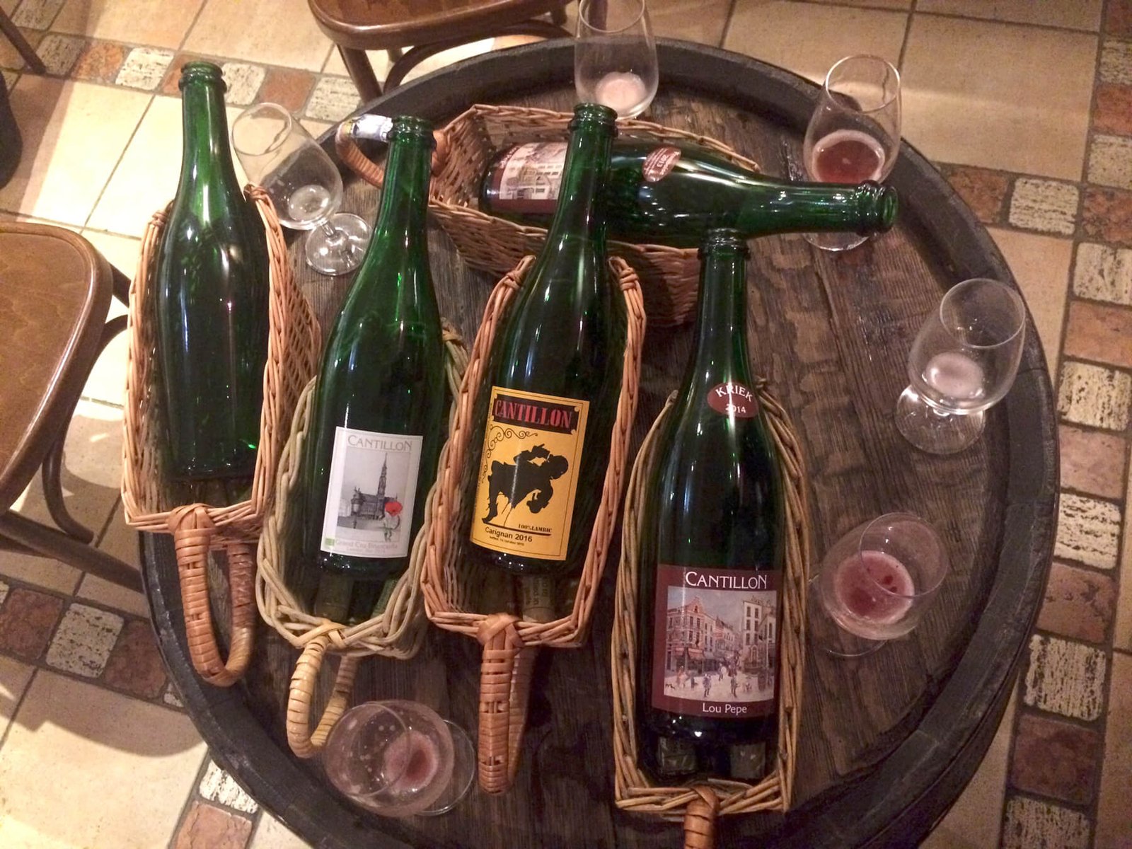 Photos of Cantillon beer bottles and glasses at the tasting Cantillon Beer Tasting