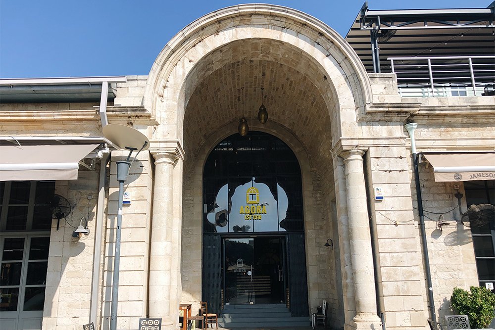 Entrance to the Agora. At the top right, there is a cafe with a large terrace