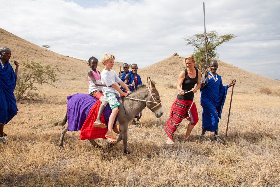 Locals ride tourists on a donkey There is entertainment for everyone in Arusha