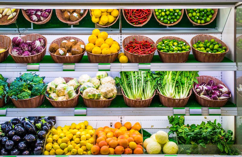 Vegetables and fruits on the supermarket counter Vegetable shelf in a supermarket