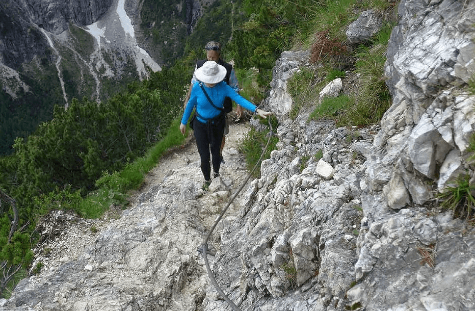 Narrow section of the trail to Lake Sorapis with cables along the cliff
