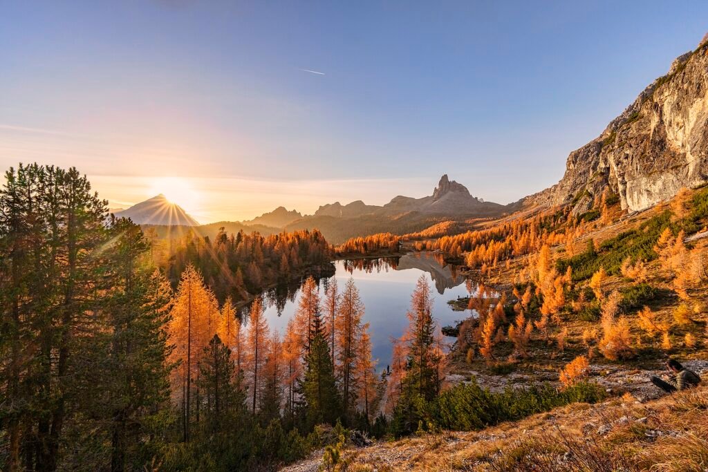 Lago di Federa surrounded by golden autumn larches below the Dolomite peaks near Cortina d'Ampezzo