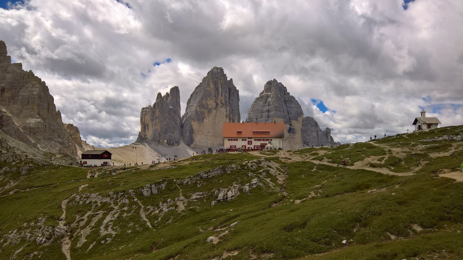 The three towers of the Tre Cime di Lavaredo behind Rifugio Locatelli on a summer day