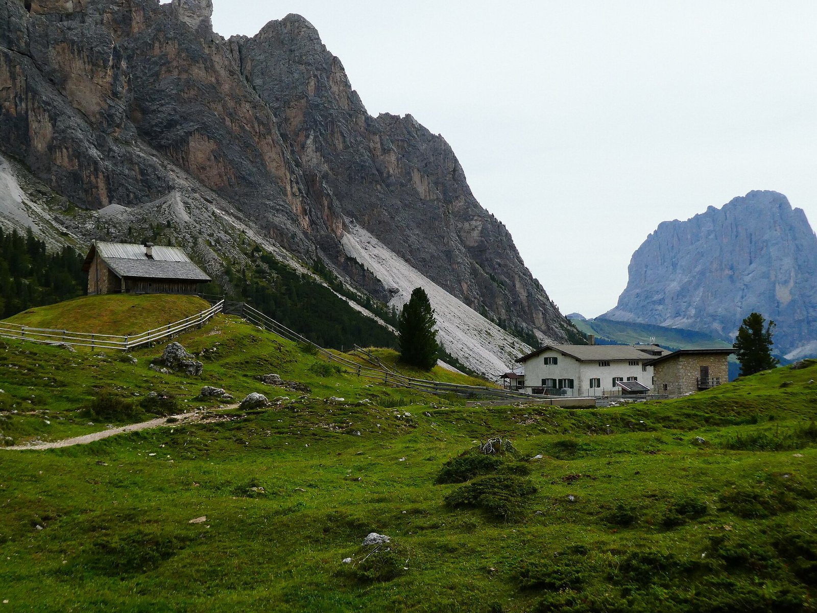 Rifugio Firenze (Regensburger Hütte) mountain hut on a green alpine meadow below Dolomite cliffs