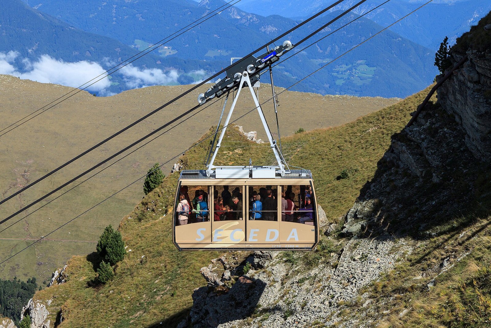 The red Seceda cable car climbing between Furnes and the Seceda top station above Val Gardena